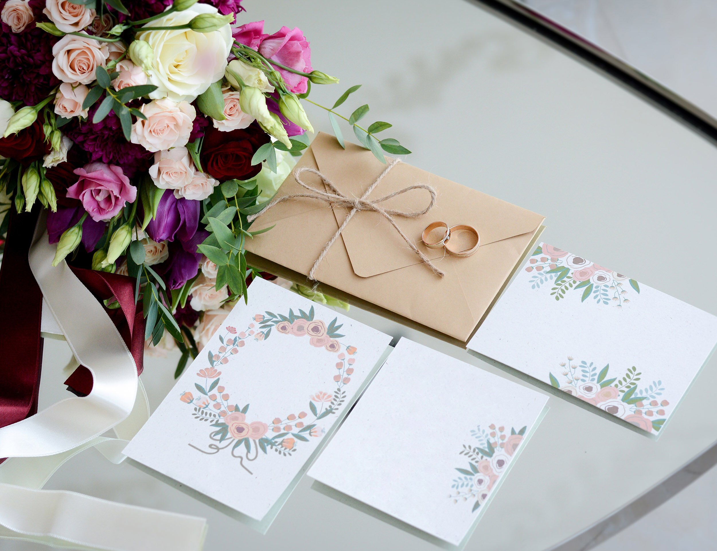 Beautiful wedding planner cards with flowers and rings, symbolizing a well-organized wedding itinerary.